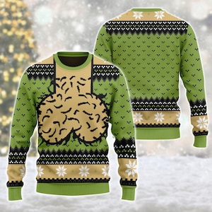 Könnte beinhalten: Ein langärmeliger Pullover mit Rundhalsausschnitt in Grün und Beige mit einem sich wiederholenden geometrischen Muster. Die Vorderseite zeigt eine große, beige, gehirnartige Grafik mit schwarzen Umrissen, während die Rückseite ein durchgehendes Muster aufweist.