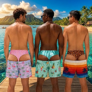 May include: Three pairs of swim shorts featuring distinct patterns: one with pink and white vertical stripes and flamingos, one with a tropical cocktail and palm tree print, and one with a sunset gradient featuring palm tree silhouettes.