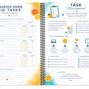 May include: A spiral-bound planner spread featuring a Breaking Down Big Tasks worksheet on the left and a Task Management guide on the right. The pages are decorated with orange slices, blue water-themed borders, and instructional text.