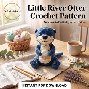 May include: A blue and cream crocheted otter toy holding a white stone, accompanied by a basket of yarn balls, a steaming mug, and an open instruction book with two wooden crochet hooks. Text reads Little River Otter Crochet Pattern.