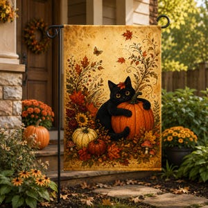May include: A rectangular garden flag featuring a black cat hugging a large orange pumpkin. The design includes autumn foliage, sunflowers, mushrooms, and a butterfly on a warm, golden-toned background with swirling decorative patterns.