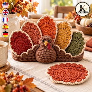 May include: A crochet turkey-shaped holder containing four circular coasters in shades of red, orange, yellow, and green. The turkey has a brown body, a yellow beak, and a red wattle. An additional red crochet coaster lies flat in front of the holder.
