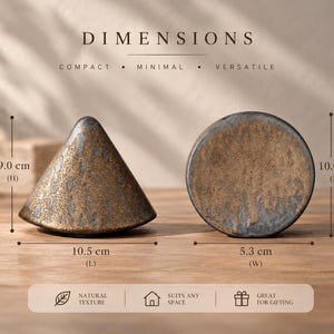May include: Two ceramic decorative objects with a textured, mottled grey and gold finish. One is conical, measuring 9.0 cm in height and 10.5 cm in length. The other is circular, measuring 10.0 cm in height and 5.3 cm in width. Text reads DIMENSIONS.
