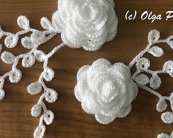 May include: Two white crocheted flowers with a stem of white crocheted leaves on each side. (c) Olga Poltava