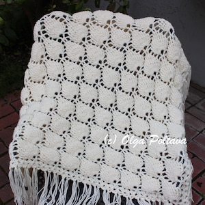 May include: A white crocheted throw blanket with a fringe border. The blanket has a repeating pattern of small circles. The text (c) Olga Poltava is visible in the lower right corner of the image.