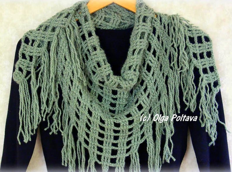 May include: A green crocheted shawl with fringe. The shawl is draped over a black shirt. The text (c) Olga Poltava is visible on the shawl.