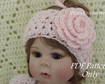 May include: A pink crocheted headband with a large flower accent. The headband is worn by a doll with brown hair and blue eyes. The text "PDF Pattern Only" is visible in the image.