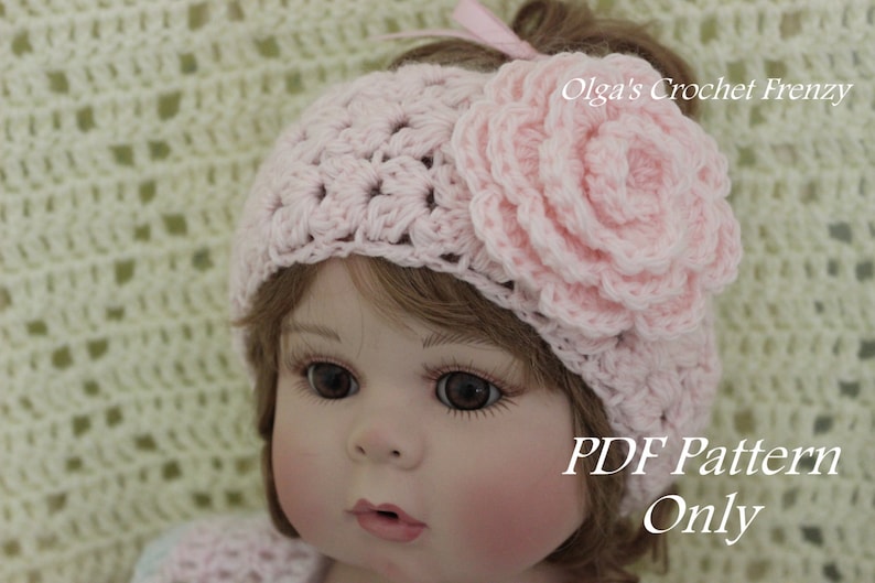 May include: A pink crocheted headband with a large flower accent. The headband is worn by a doll with brown hair and blue eyes. The text "PDF Pattern Only" is visible in the image.
