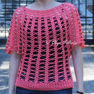 May include: Coral-colored crochet top with a loose, open weave design. The short-sleeved top has a boat neck and a scalloped edge on the sleeves. The text "(c) Olga Poltava" is visible on the right side of the top.