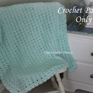 May include: A light blue crochet blanket draped over a white chair. The text "Crochet Pattern Only" is written in white on a blue background. The text "Olga's Crochet Frenzy" is written in white on a blue background.