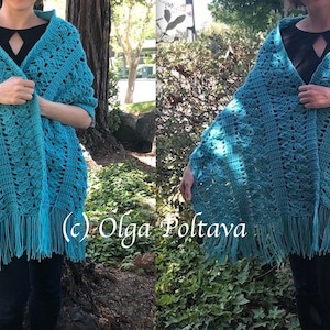 May include: A teal crochet shawl featuring an intricate openwork pattern and long fringe along the bottom edge. The garment is draped over the shoulders and includes the text (c) Olga Poltava printed in white across the center of the image.