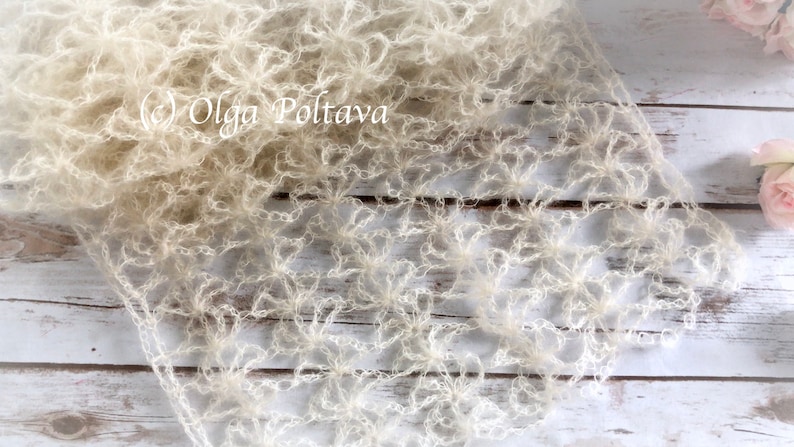May include: A white crocheted shawl with a delicate floral pattern. The shawl is made of a soft, lightweight yarn and has a flowing, ethereal look.  (c) Olga Poltava