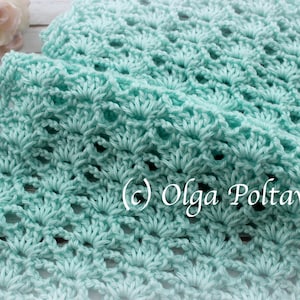 May include: A light blue crocheted scarf with a delicate, lacy pattern. The scarf is made with a soft yarn and has a flowing, elegant drape. (c) Olga Poltava