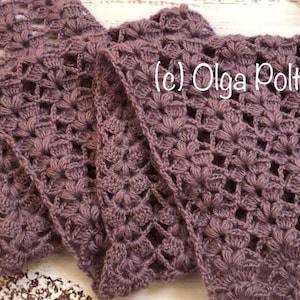 May include: A close-up of a crocheted scarf in a deep purple color. The scarf is made with a delicate openwork pattern and has a textured, soft look. The text (c) Olga Poltava is visible in the image.
