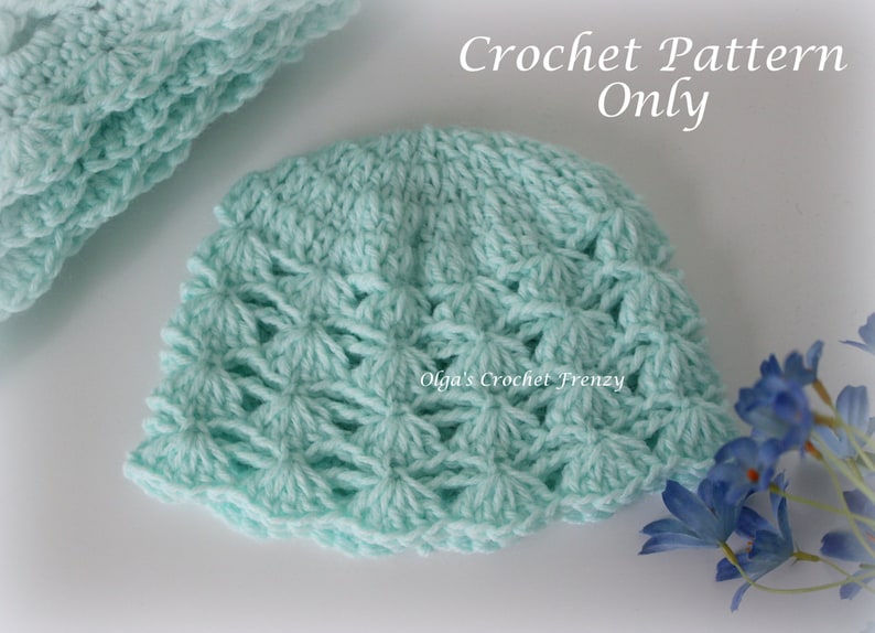 May include: A light blue crochet hat with a delicate, lacy pattern. The hat is made with a soft yarn and has a simple, elegant design. Crochet Pattern Only.