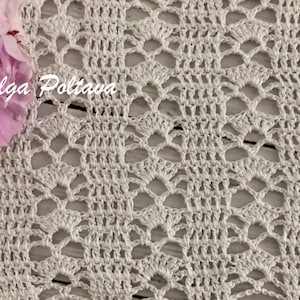 May include: Close-up of a white crocheted lace fabric with a delicate openwork pattern. The fabric has a textured appearance and is adorned with pink flowers in the upper left corner. The text "(c) Olga Poltava" is visible.