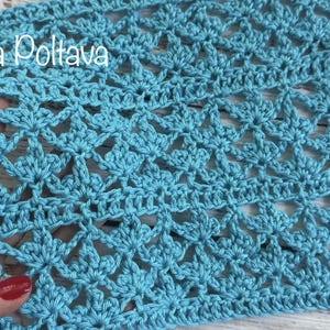 May include: A light blue crochet fabric swatch featuring a repeating fan-like stitch pattern with openwork details. The textile displays a consistent, intricate texture throughout. The text (c) Olga Poltava is visible in the upper left corner.