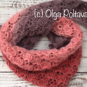 May include: A crocheted cowl in shades of pink and brown with a lacy pattern. The cowl is folded in half and the ends are overlapping. The text (c) Olga Poltava is visible on the cowl.