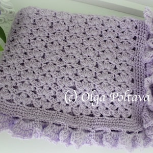 May include: A lavender crochet baby blanket with a scalloped edge. The blanket is made with a delicate stitch pattern and has a soft, fluffy texture.