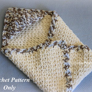 May include: A crocheted baby blanket in cream with a brown and blue trim. The blanket is folded in half and has a hood. The text "Crochet Pattern Only" is visible at the bottom of the image.
