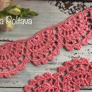 May include: Pink crocheted lace trim with a delicate pattern. (c) Olga Poltava