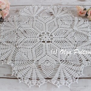 May include: White crocheted doily with a delicate floral pattern. The doily is circular and has a diameter of approximately 12 inches.
