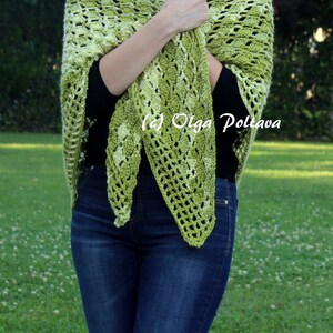 May include: A triangular crochet shawl featuring a variegated pattern of light and dark green yarn. The openwork design displays a repeating textured stitch pattern throughout the fabric. The text (c) Olga Poltava is visible on the shawl.