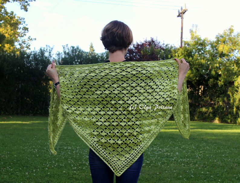 May include: A triangular crochet shawl in a vibrant lime green hue featuring an intricate openwork diamond pattern throughout the fabric. The shawl displays a textured stitch design with a decorative border and includes the text (c) Olga Poltava.