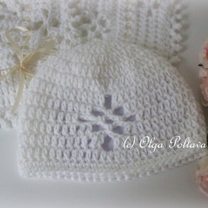 May include: White crocheted baby hat with a flower design. The hat has a hole in the center of the flower. (c) Olga Poltava