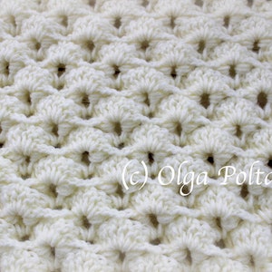 May include: Close-up of a white crocheted fabric with a repeating pattern of small circles. The fabric is soft and textured.