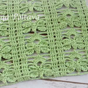 May include: A light green crocheted rectangular piece with a floral pattern. The openwork design features repeating clover-like shapes within a grid. The text "(c) Olga Poltava" is visible in the upper left corner. The piece is likely a decorative item.