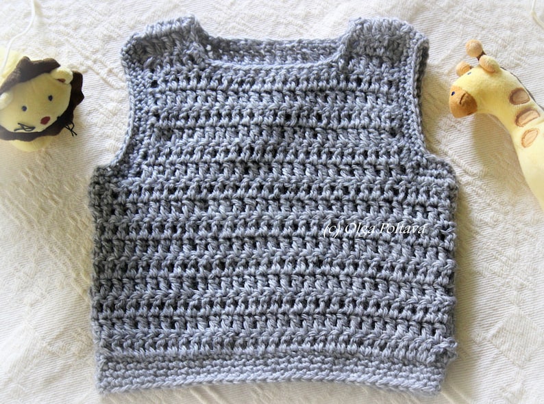 May include: A gray crocheted sleeveless vest with a round neckline.
