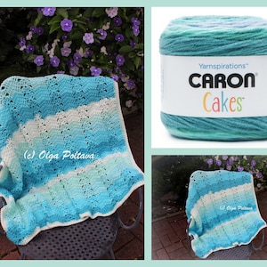 May include: A blue and white crocheted baby blanket with a wavy design and scalloped edge, draped over a chair. A ball of Caron Cakes yarn in similar colours is also shown. The blanket is made of yarn.