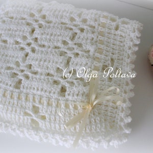 May include: White crocheted baby blanket with a delicate lace pattern and a white satin ribbon tied in a bow. (c) Olga Poltava