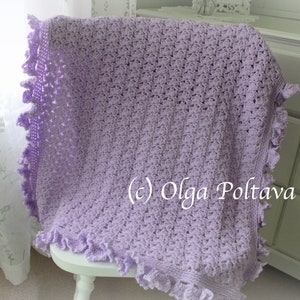 May include: A lavender crochet baby blanket with a scalloped edge. The blanket is draped over a white chair and a white dresser is in the background. (c) Olga Poltava