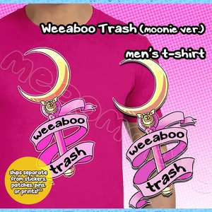 May include: Pink t-shirt with a graphic of a pink and gold crescent moon and wand with the text "Weeaboo Trash" on a pink ribbon. The text "men's t-shirt" is also on the shirt.