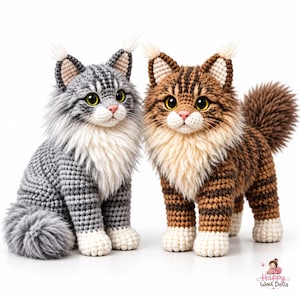 May include: Two crocheted cat dolls with long fur, one grey tabby and one brown tabby. Both feature white chest fur, white paws, pointed ears with tufts, and large yellow eyes. A small logo in the corner reads Happy Wool Dolls.