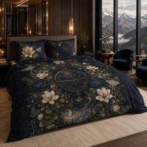 May include: A dark navy blue duvet cover and two matching pillowcases featuring a central gold celestial globe graphic surrounded by white magnolia flowers, green foliage, moths, and small stars. The bedding set has a detailed botanical print.