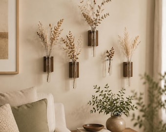 May include: Five wall-mounted propagation stations featuring rectangular dark wood blocks and clear glass test tubes. Each tube holds dried botanical stems, including grasses and eucalyptus, arranged in a staggered pattern on the wall.