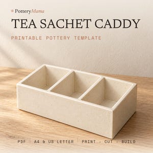 May include: A rectangular, off-white ceramic tea sachet caddy with three internal compartments and a speckled finish. The text PotteryMama TEA SACHET CADDY PRINTABLE POTTERY TEMPLATE PDF A4 & US LETTER PRINT - CUT - BUILD is visible.