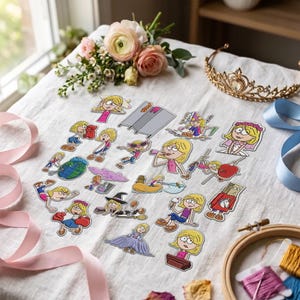 May include: A collection of twenty-one die-cut stickers featuring a cartoon blonde character in various outfits and activities, including boxing, wearing a wedding dress, a witch costume, and a paper bag mask, arranged on a white fabric surface.