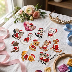 May include: A collection of eleven die-cut stickers featuring various cartoon cats wearing red and white Santa Claus outfits. The stickers display different feline characters in diverse poses, including sitting, lying down, and playing, all dressed in festive holiday attire.