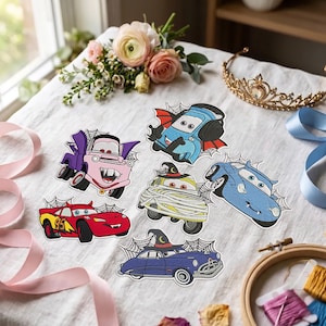 May include: A collection of six embroidered patches featuring cartoon cars in Halloween costumes, including a red car with devil horns, a purple tow truck with vampire fangs, a blue car with bat wings, a mummy car, and a blue car with a witch hat.