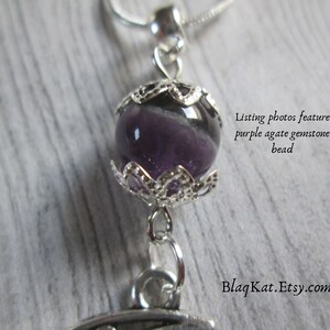 Close up of the gemstone bead, purple agate that is featured on this necklace