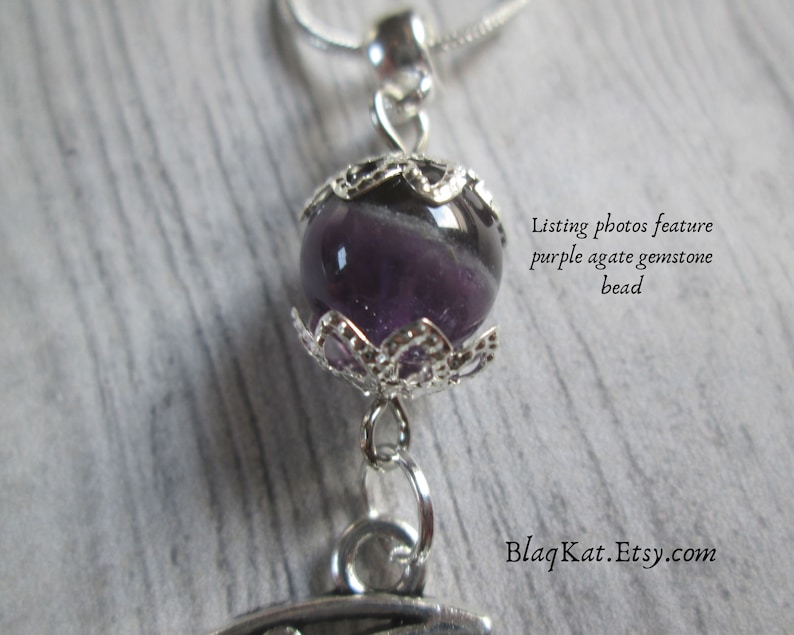 Close up of the gemstone bead, purple agate that is featured on this necklace