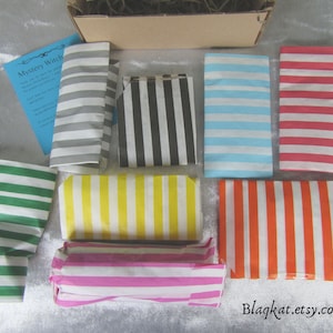 Photo of a Medium Box with 8 items all individually wrapped in stripey paper bags