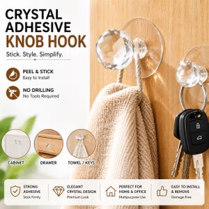 May include: A clear crystal adhesive knob hook with a faceted spherical head and a circular transparent base. The product is shown mounted on a wooden surface, holding a beige towel and a set of metal keys on a ring, with instructional text.