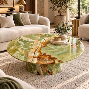 May include: A round coffee table featuring a polished green onyx surface with prominent brown and white veining. The table is supported by a matching cylindrical pedestal base made of the same green stone, creating a cohesive and solid appearance.