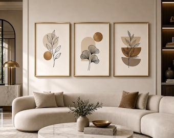 May include: Three framed vertical wall art prints featuring black line drawings of botanical leaves layered over geometric shapes in shades of beige, tan, and brown. The prints are displayed in thin gold frames on a light-colored wall.