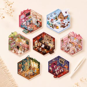 May include: A collection of seven hexagonal stickers featuring detailed illustrations of cats in various settings, including a cafe, a snowy landscape, a flower shop, a ramen restaurant, a bakery, a library, and a movie theater labeled Purrflix.